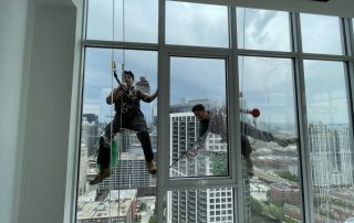 Window washers cleaning the exterior windows of a Chicago apartment building