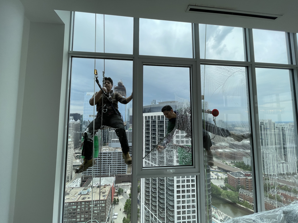 Window washers cleaning the exterior windows of a Chicago apartment building