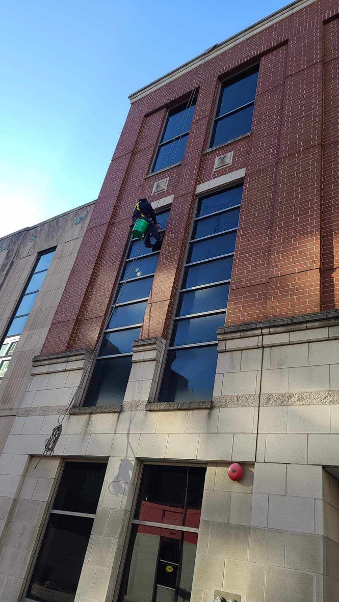 Window washer descending down mid-rise building