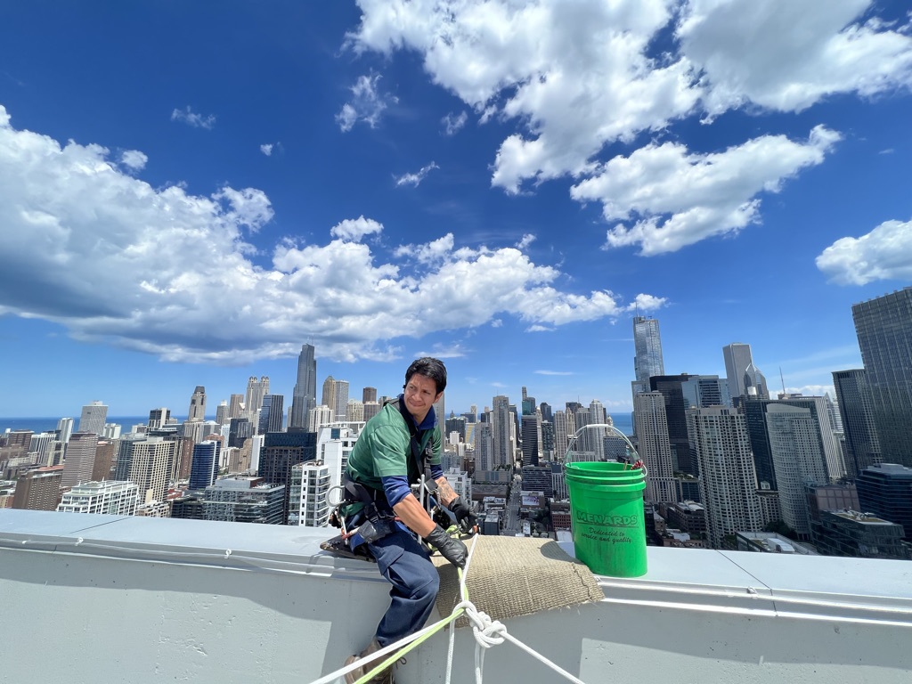 Window cleaner checking their safety equipment in Chicago