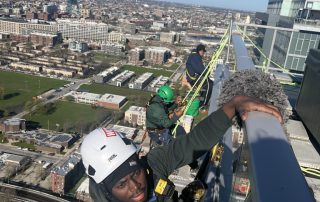 Green Clean team washing a Chicago high-rise building with proper equipment