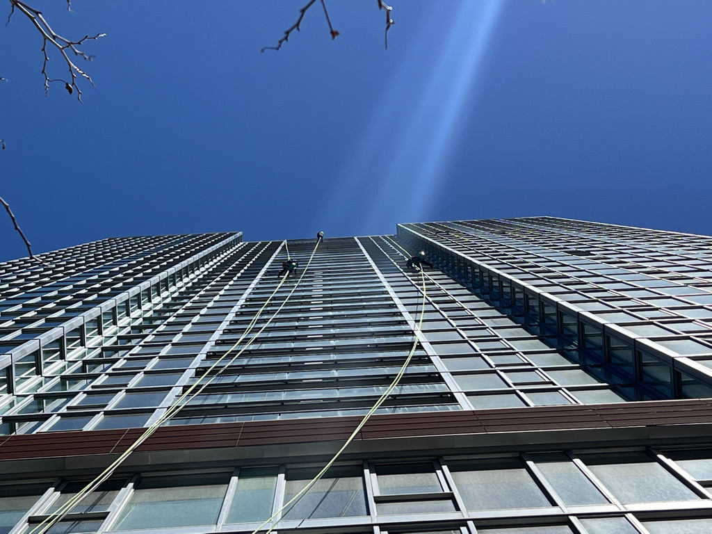 Using OSHA safety equipment window washers clean a Chicago high rise building