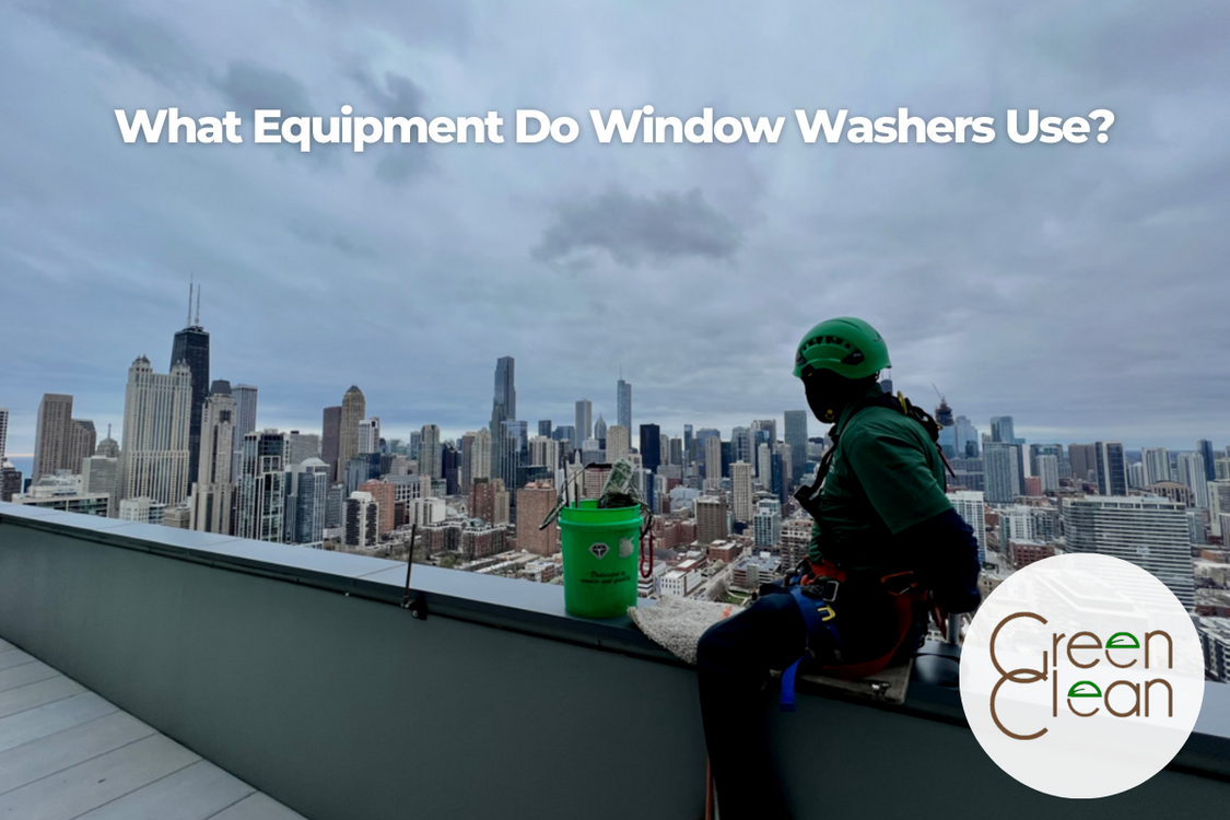 Green Clean window washer in full safety gear looking at Chicago's city view.